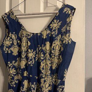 A summer blue dress with gold like  large fleur de lis (like)  gothic design